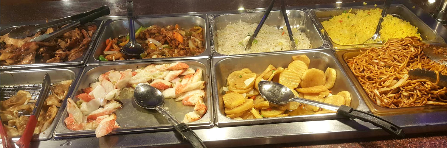Buffet trays with dumplings, noodles, fried rice and more